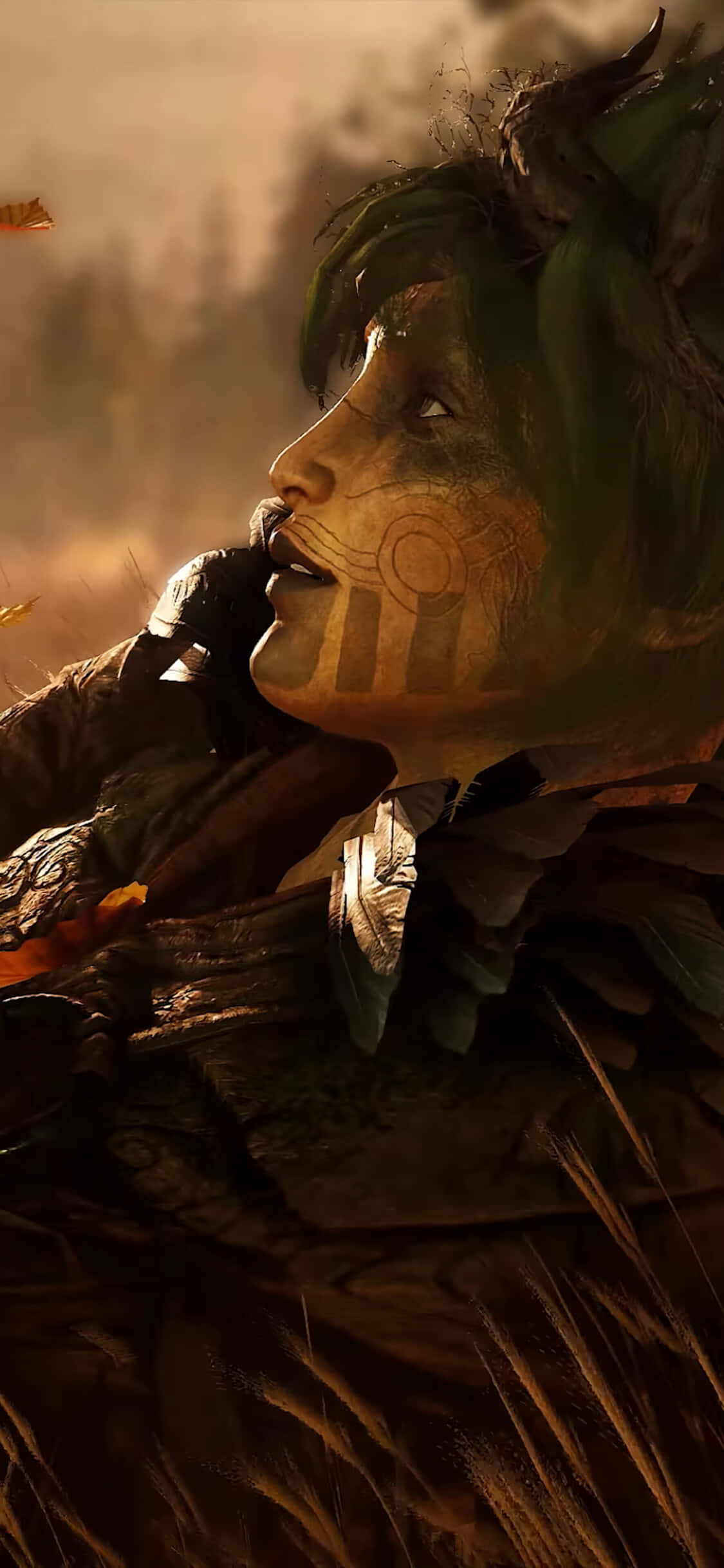 iPhone X《Greedfall》遊戲角色背景 壁紙 — 一位擁有綠色頭髮和部落臉部彩繪的戰士，在煙霧瀰漫、溫暖金色光芒照耀的戰場上向上凝視。