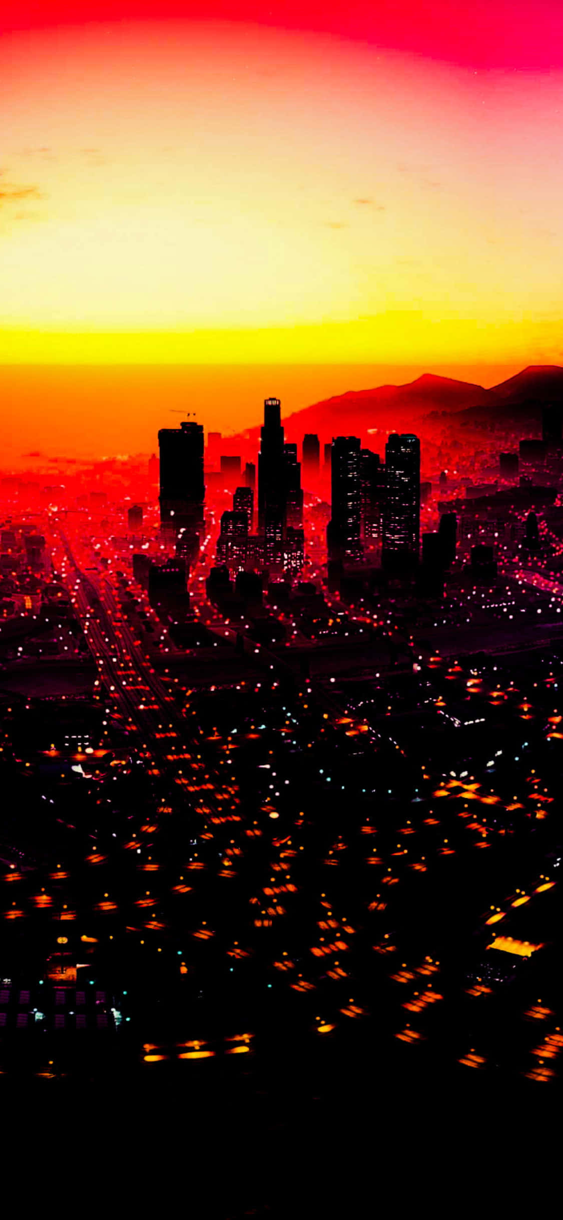 iPhone X《GTA V》背景：紅色夕陽城市鳥瞰 壁紙 — 夕陽西下，火紅與橙色的天空映照著廣闊的城市景觀，街道閃爍著光芒，摩天大樓的剪影顯得格外突出。