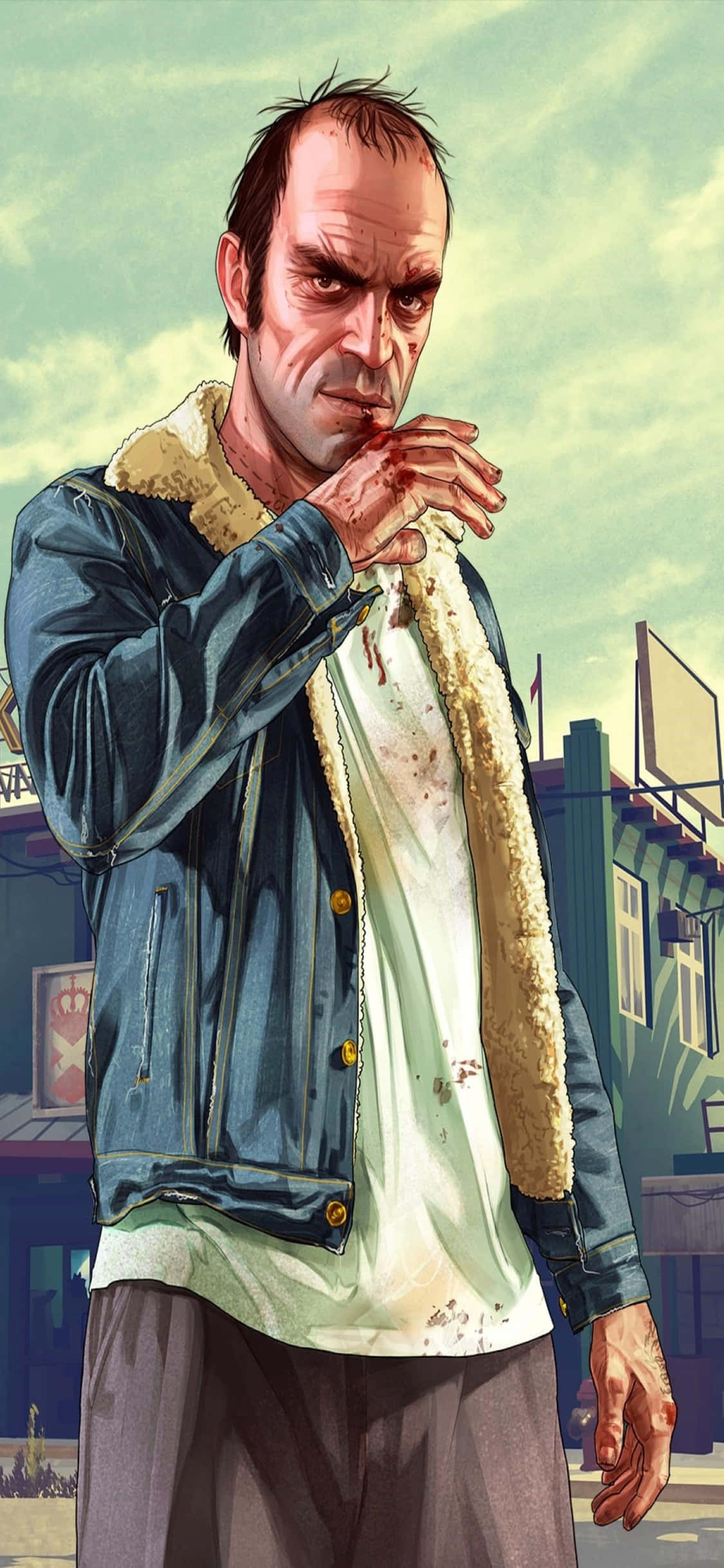iPhone X《GTA V》背景：特洛伊穿牛仔外套 壁紙 — 一個粗獷的動畫男子穿著沾滿血跡的牛仔外套，將流血的手放在褪色的城市背景前，眼神銳利地凝視。