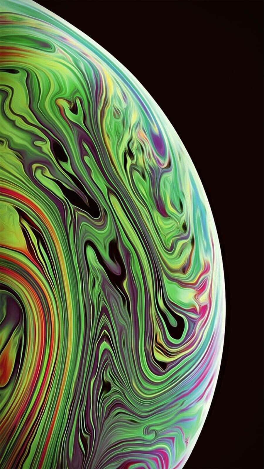 iPhone X 搭載 OLED 顯示屏 壁紙 — 一個充滿活力的旋轉肥皂泡，帶有霓虹綠、紫色和紅色色調，背景為深色。