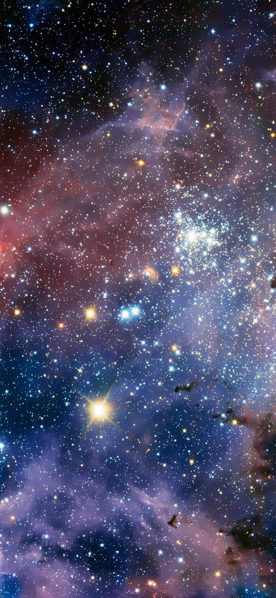 充滿活力的宇宙星雲，帶有發光的星星和漩渦狀的紫色、藍色、粉紅色氣體雲。