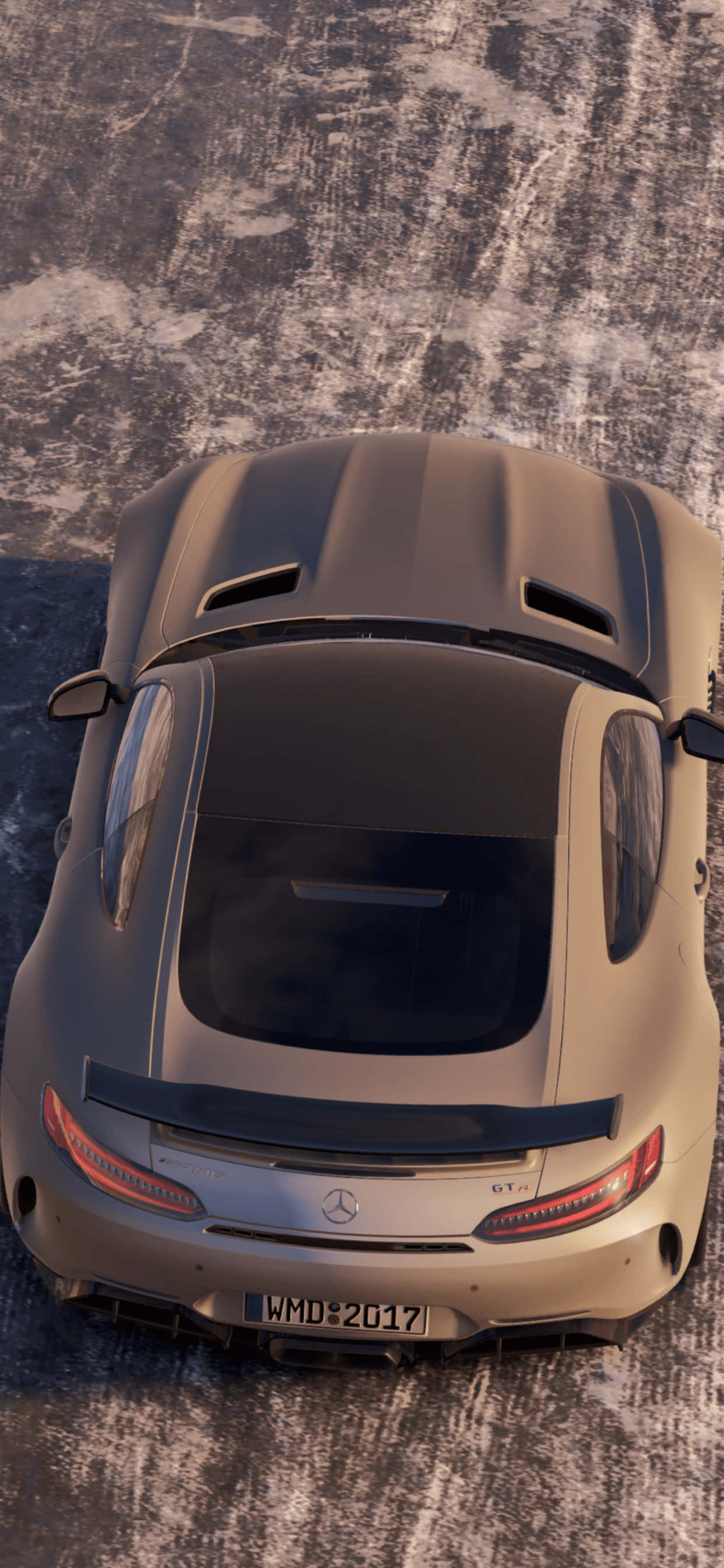 iPhone XS Max Project Cars 2 磨砂梅賽德斯-AMG AMG GT 背景 壁紙 — 一輛啞光金色的Mercedes-AMG GT R跑車，在明亮的日光下從上方俯瞰，停在有紋理的混凝土表面上。