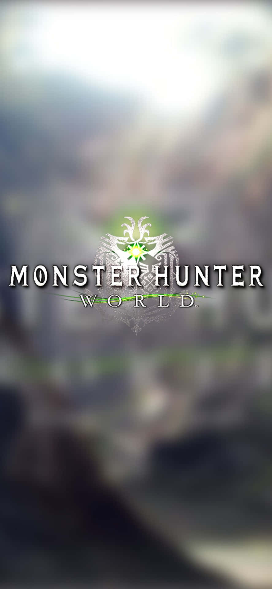 Monster Hunter World 遊戲標誌在霧氣山景中發出綠光。