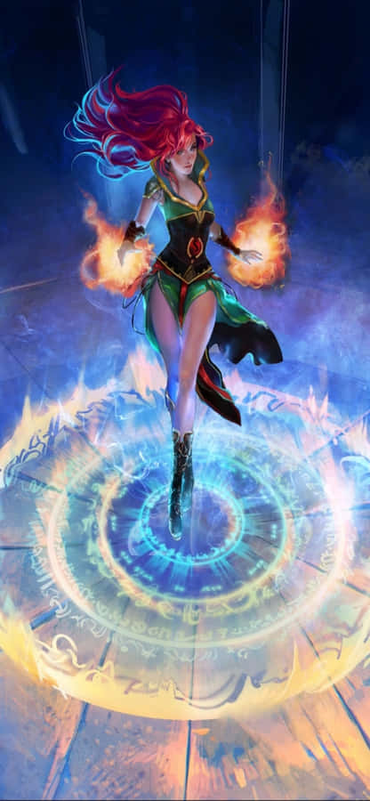 iPhone XS《Runescape》背景：女巫阿里安娜 壁紙 — 一位紅髮法師身穿綠色和黑色長袍，漂浮在發光的藍色魔法陣上方，雙手操控火焰，背景是黑暗神秘的氛圍。