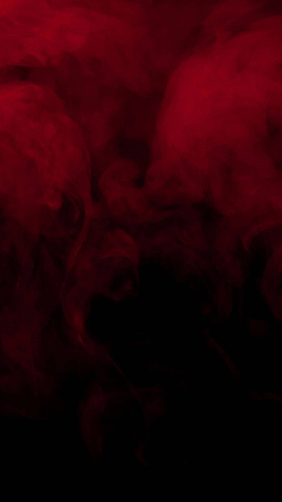 在黑色背景上旋轉的紅色煙霧營造出戲劇性和強烈的氛圍。