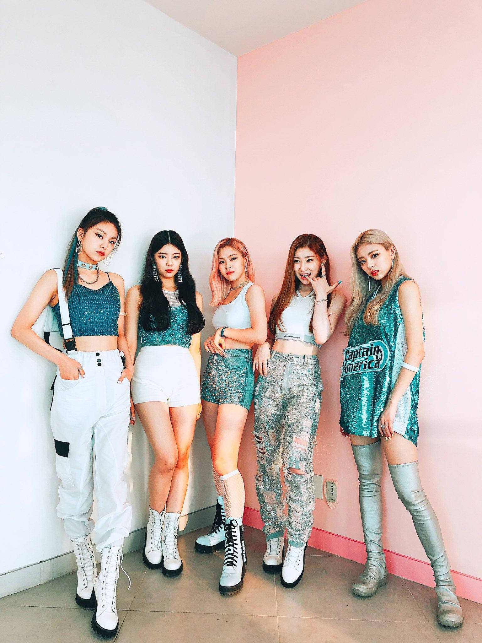ITZY《ICY》時代 壁紙 — 五位時尚年輕女性穿著潮流服裝，在光線明亮的室內空間中，自信地以粉紅和白色牆壁為背景擺姿勢。