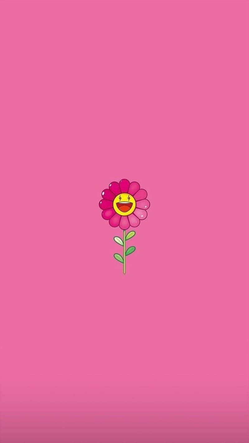 J Balvin 粉紅村上隆花朵 壁紙 — 一朵開心的卡通花，帶著笑臉，在純粉紅色背景上綻放。