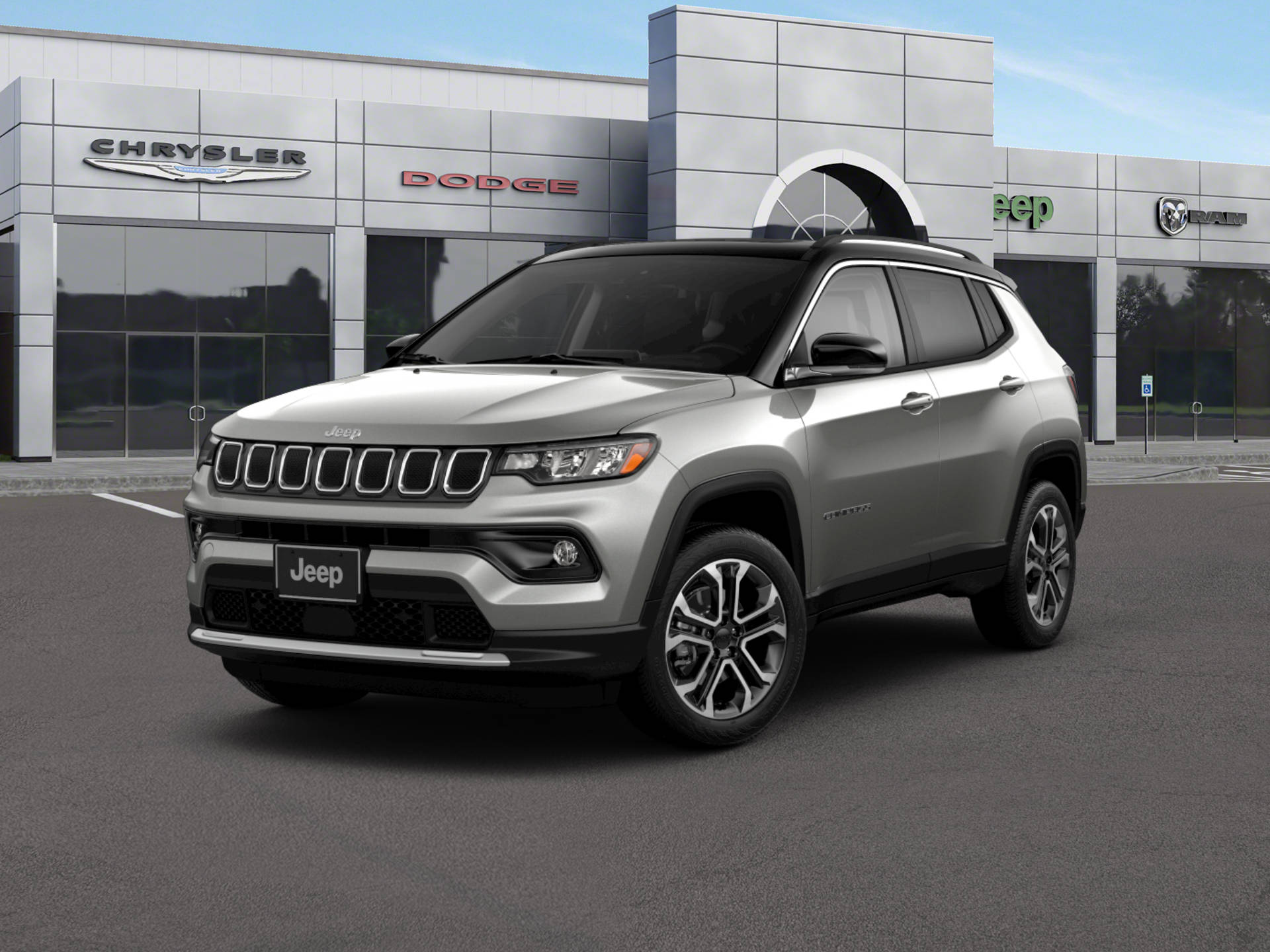 銀色Jeep Compass停泊於車行外 壁紙 — 一輛時尚的銀色Jeep Compass SUV停泊在現代化經銷商前，該經銷商帶有Chrysler Dodge Ram品牌標誌，背景是晴朗的藍天。