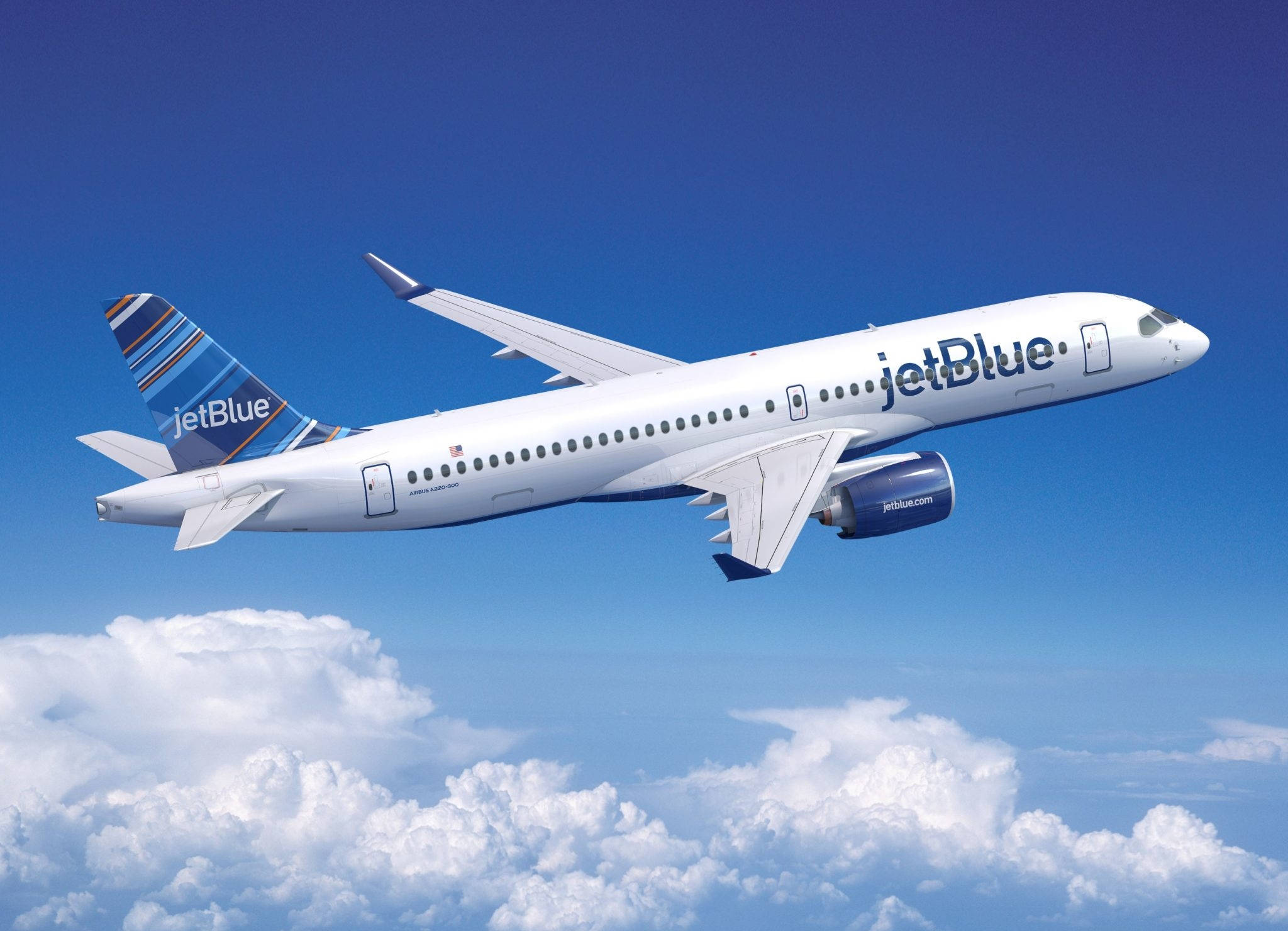 JetBlue航空飛機在藍色多雲天空飛行 壁紙 — 一架白色的JetBlue飛機在晴朗的藍天下翱翔於蓬鬆的白雲之上。