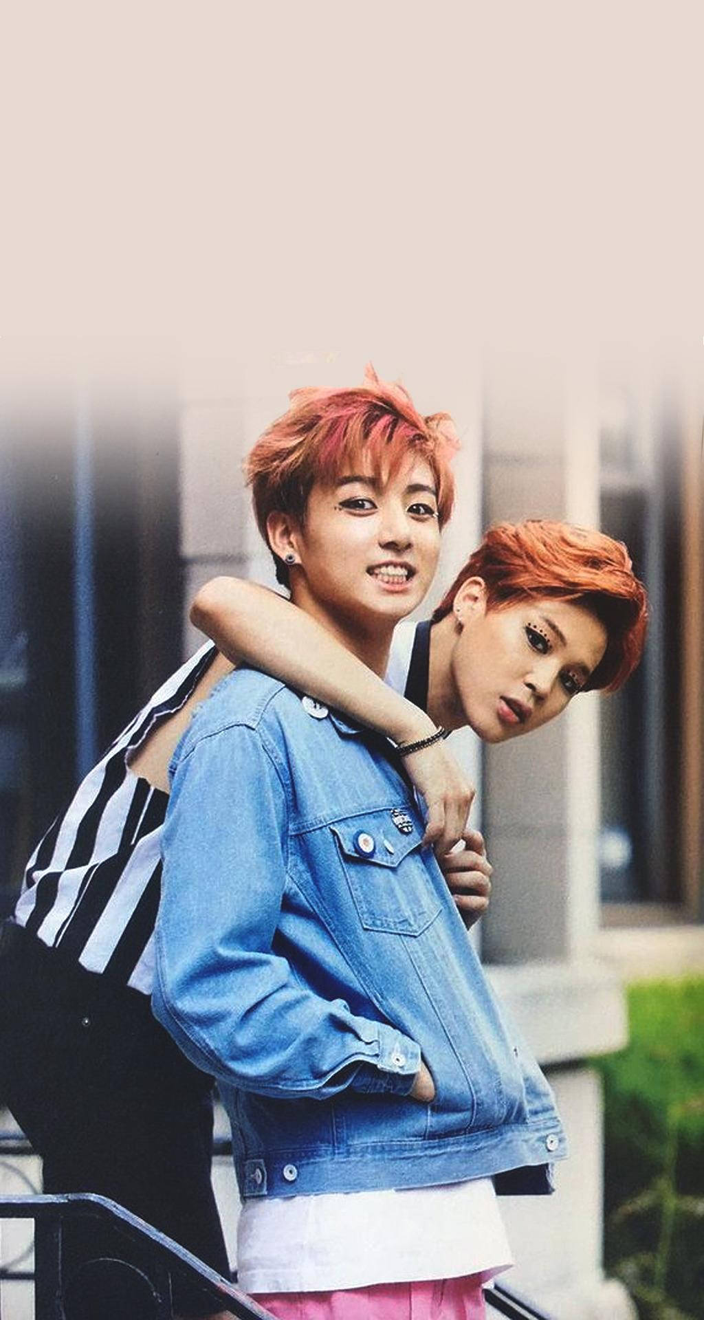 Jikook 成為兄弟情 壁紙 — 兩名擁有鮮豔紅髮的年輕男子在戶外樓梯上緊密擺姿勢，一人穿牛仔外套，另一人穿條紋上衣。