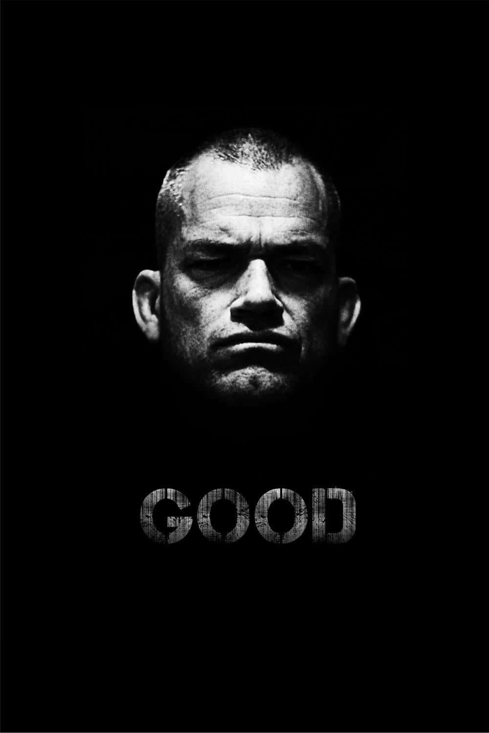 Jocko Willink 黑白肖像 壁紙 — 一個男人強烈面孔的鮮明黑白肖像，在黑暗中照亮，下方有GOOD字樣。