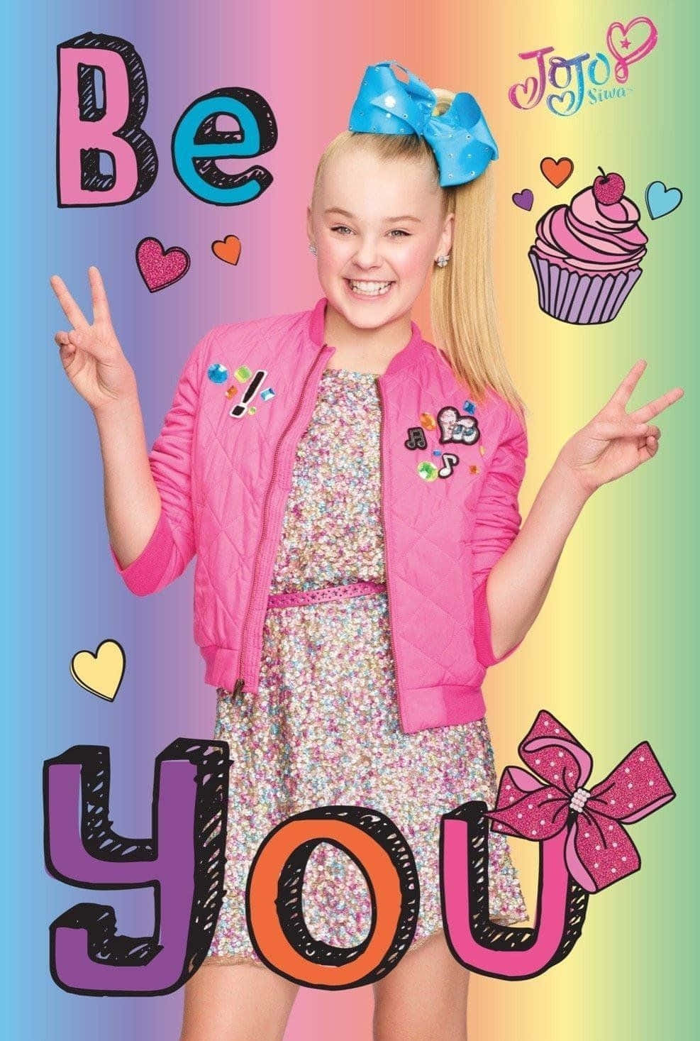 《JoJo的奇妙冒險》——準備迎接驚奇無比的旅程！ 壁紙 — Jojo Siwa 穿著粉紅色外套，在帶有心形和紙杯蛋糕的彩虹背景前燦爛微笑。