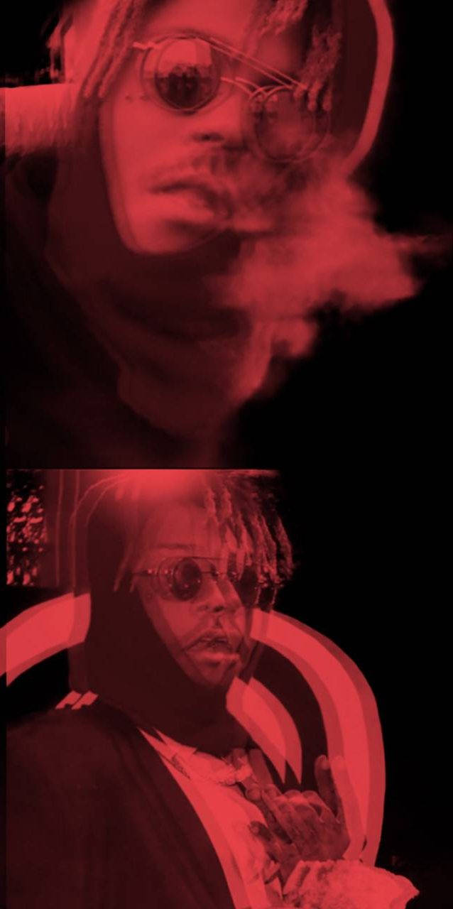 酷炫 Juice WRLD 電影感 壁紙 — 一個穿著連帽衫和太陽眼鏡的人在黑暗環境中，在強烈的紅光下呼出煙霧。