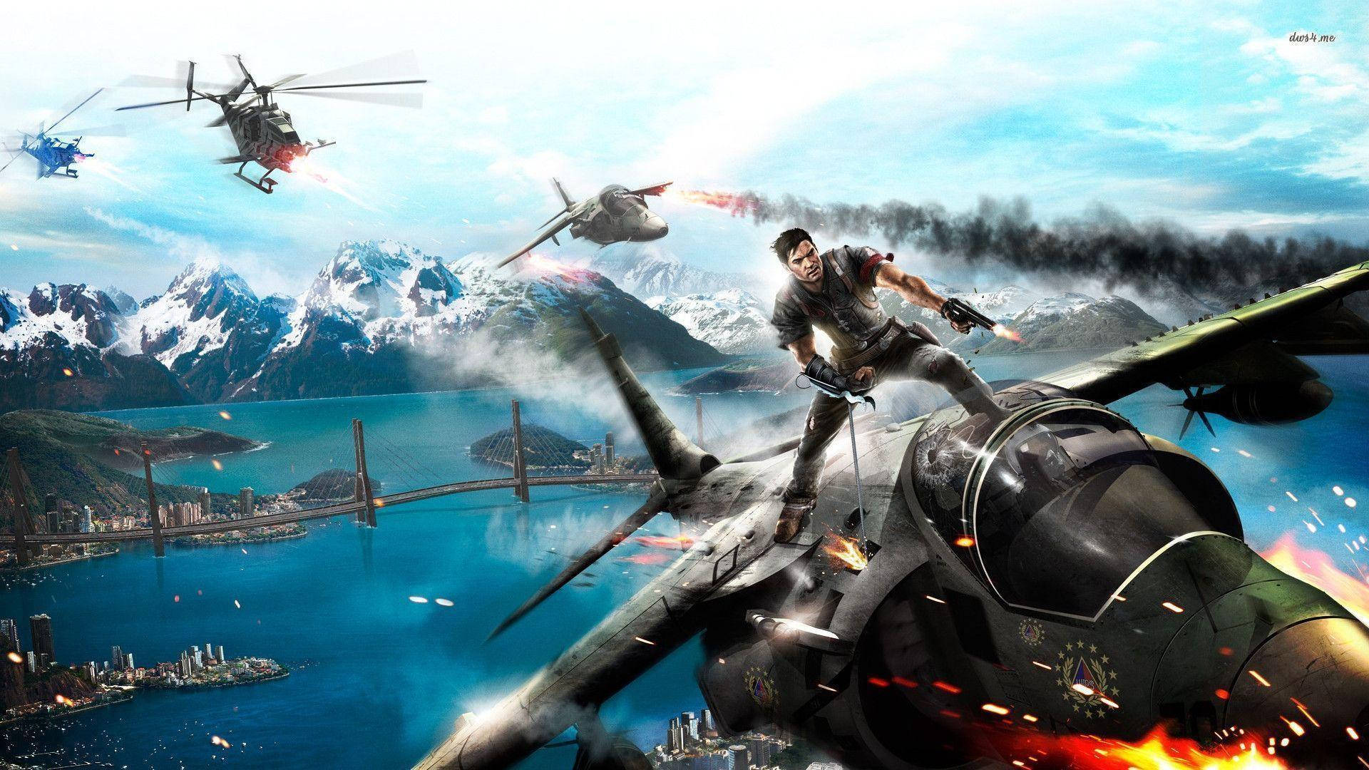 Just Cause 2 戰鬥機群 壁紙 — 一名男子緊抓著一架燃燒的戰鬥機，直升機和爆炸在沿海城市上空肆虐，背景是白雪覆蓋的山脈。