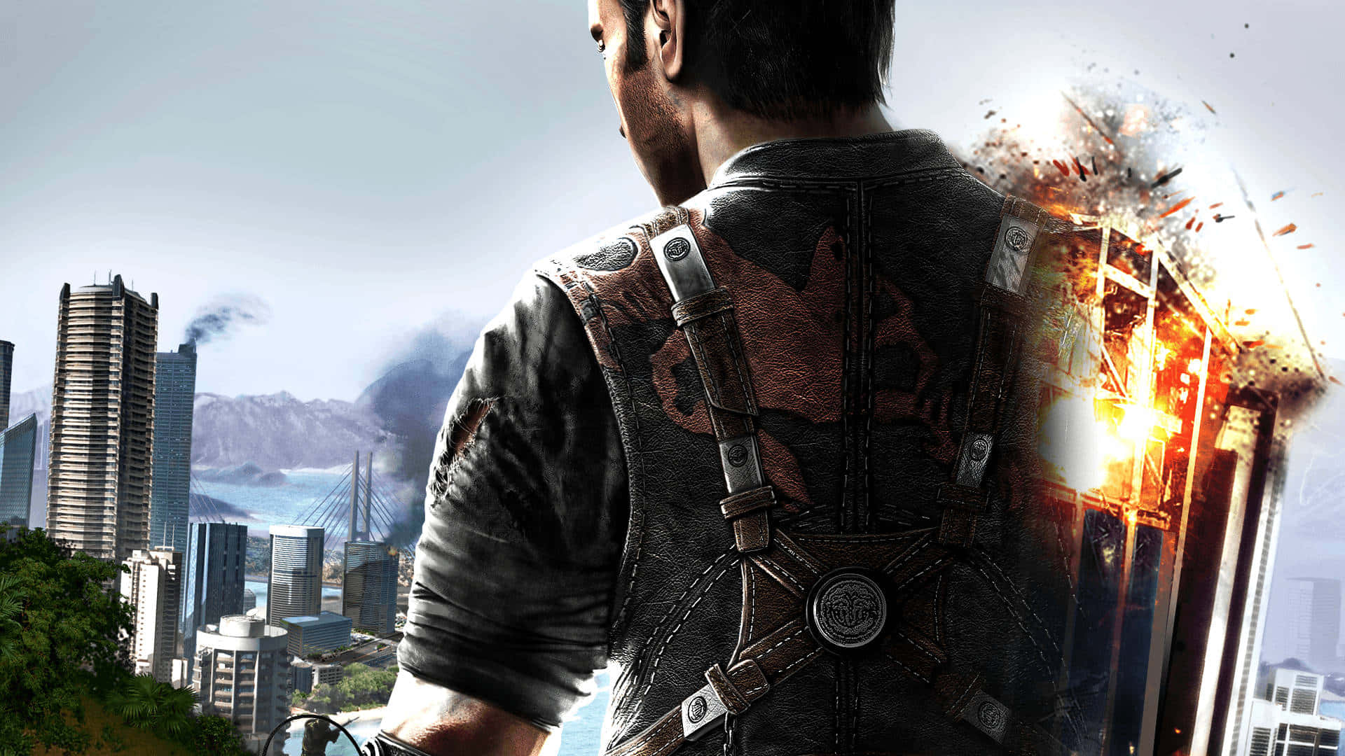 Just Cause 4 灰燼城市背景 壁紙 — 一個穿著皮背心的男人站在那裡俯瞰城市景觀，身後發生爆炸。