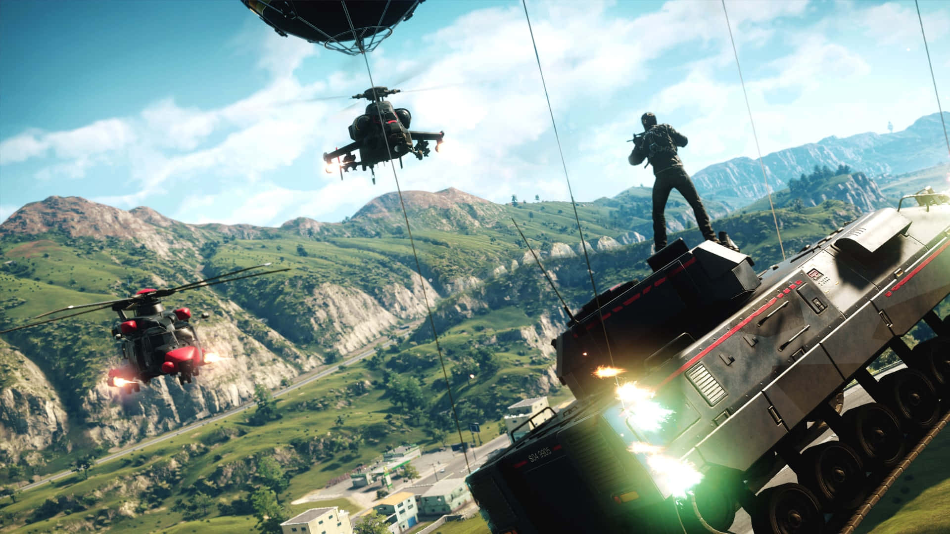 Just Cause 4 綠山飛機背景 壁紙 — 一名士兵站在坦克上，直升機在明亮的藍天下飛越山區戰場。