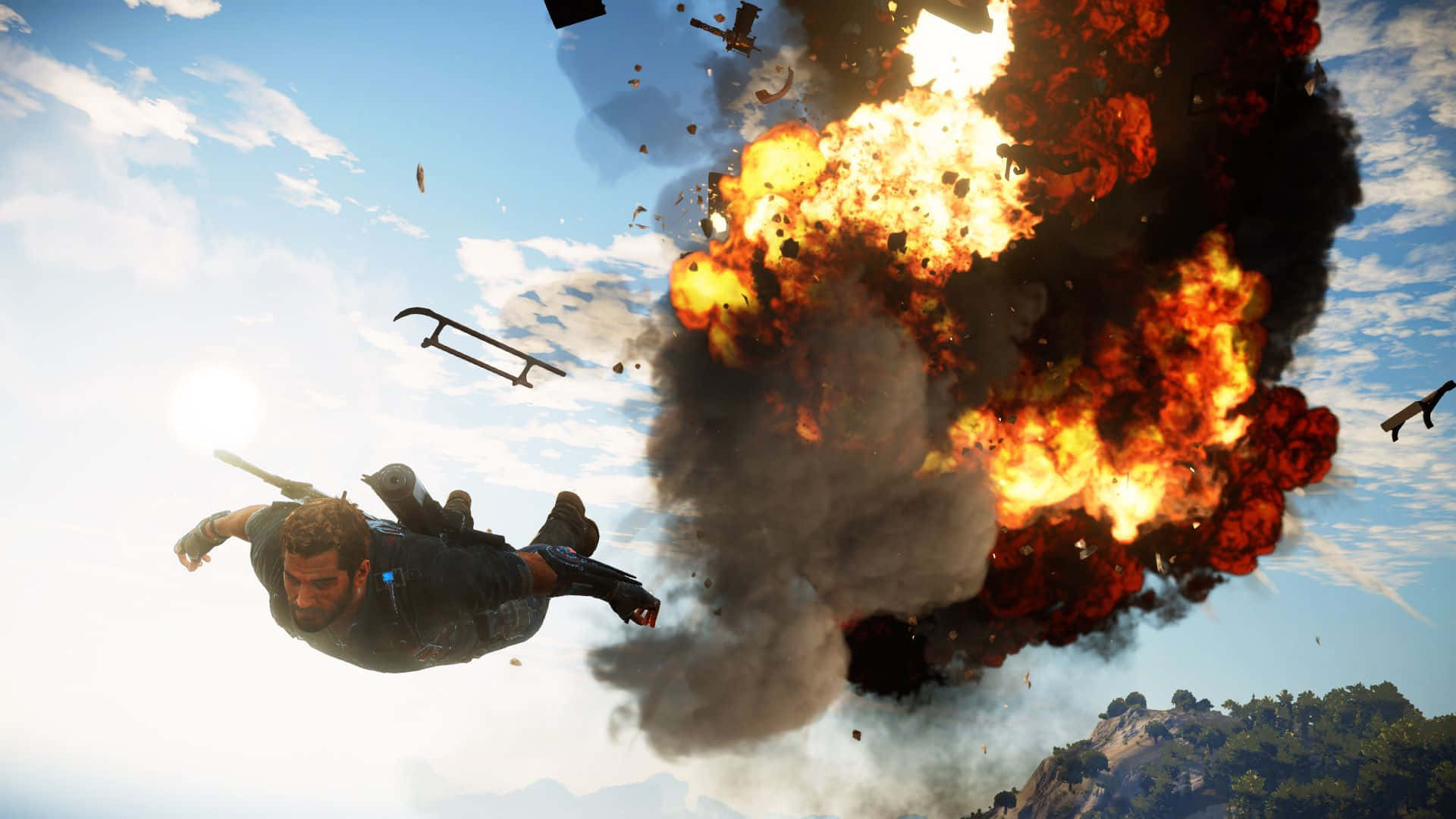 《Just Cause 4》背景中的電光火石戰鬥 壁紙 — 一名男子在天空中翻滾，身後發生巨大爆炸，碎片在明亮的陽光下四散。