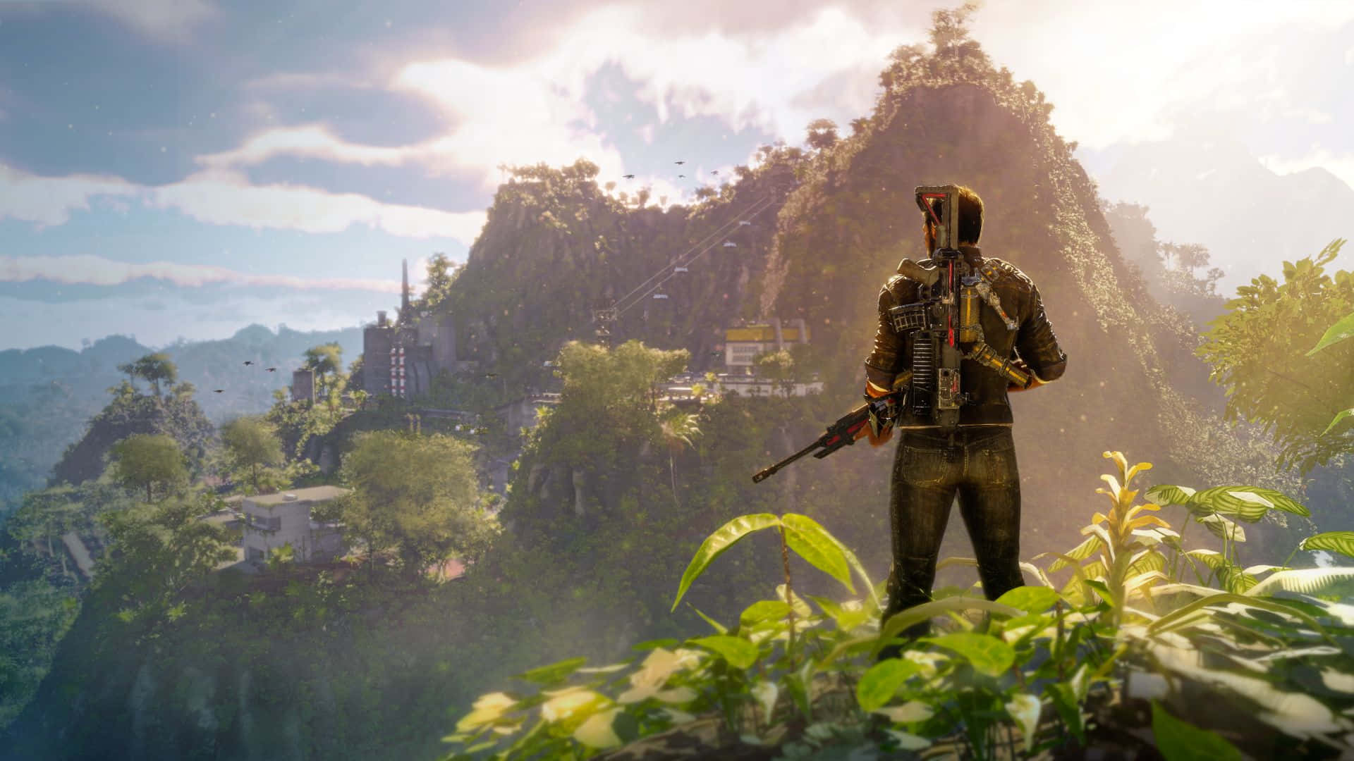 《Just Cause 4》遊戲高畫質場景 壁紙 — 一名士兵站在叢林山脊上，俯瞰沐浴在金色夕陽下的山村。