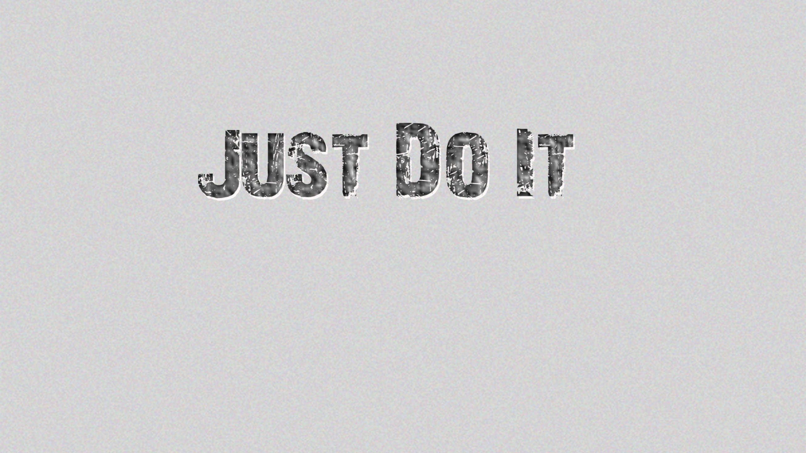Just Do It 灰色 壁紙 — 「just do it」呢句短語以粗體紋理字體顯示喺純淺灰色背景上。