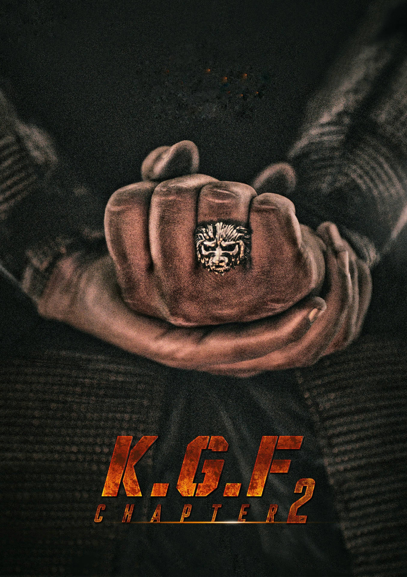 戴著獅子戒指的緊握拳頭和火焰般的KGF Chapter 2標題文字。