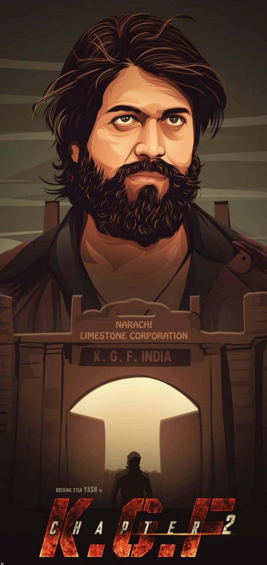 一位留鬍鬚、身穿棕色外套的男子站在一個帶有KGF India標誌的石拱門前。