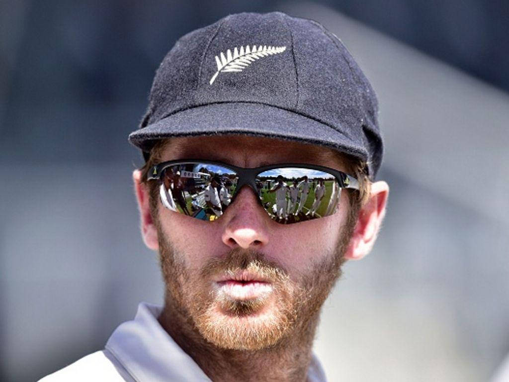 Kane Williamson 戴反光太陽眼鏡 壁紙 — 一位留鬍鬚的男子戴著紐西蘭蕨類帽子和反光太陽眼鏡在戶外。