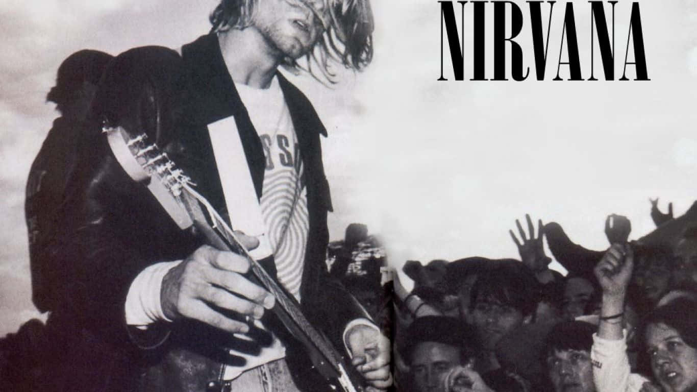 涅槃 桌布 壁紙 — Kurt Cobain 在舞台上彈結他，人群伸手觸碰他的黑白照片。