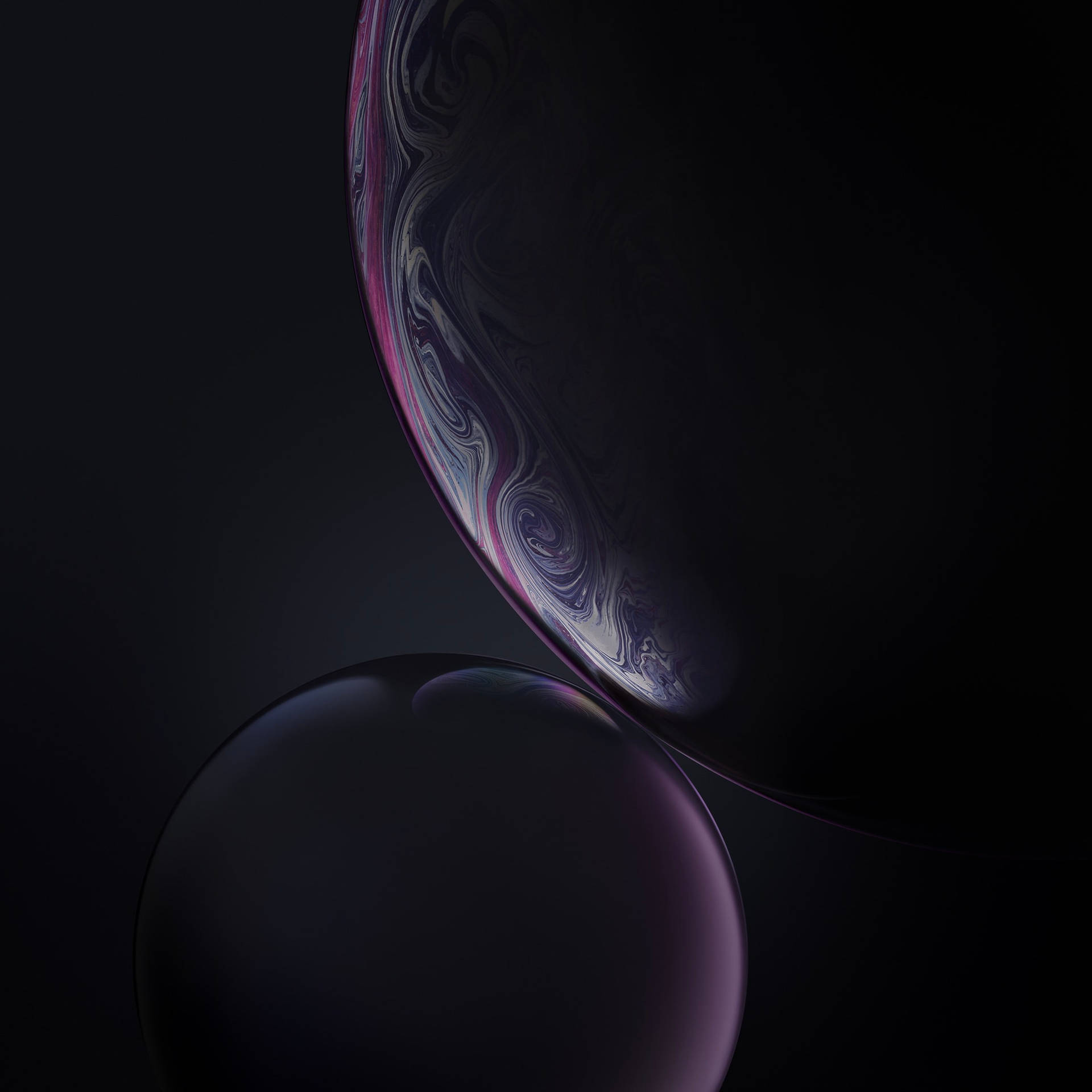 兩個漂浮的球體，其中一個在黑暗背景上顯示宇宙漩渦