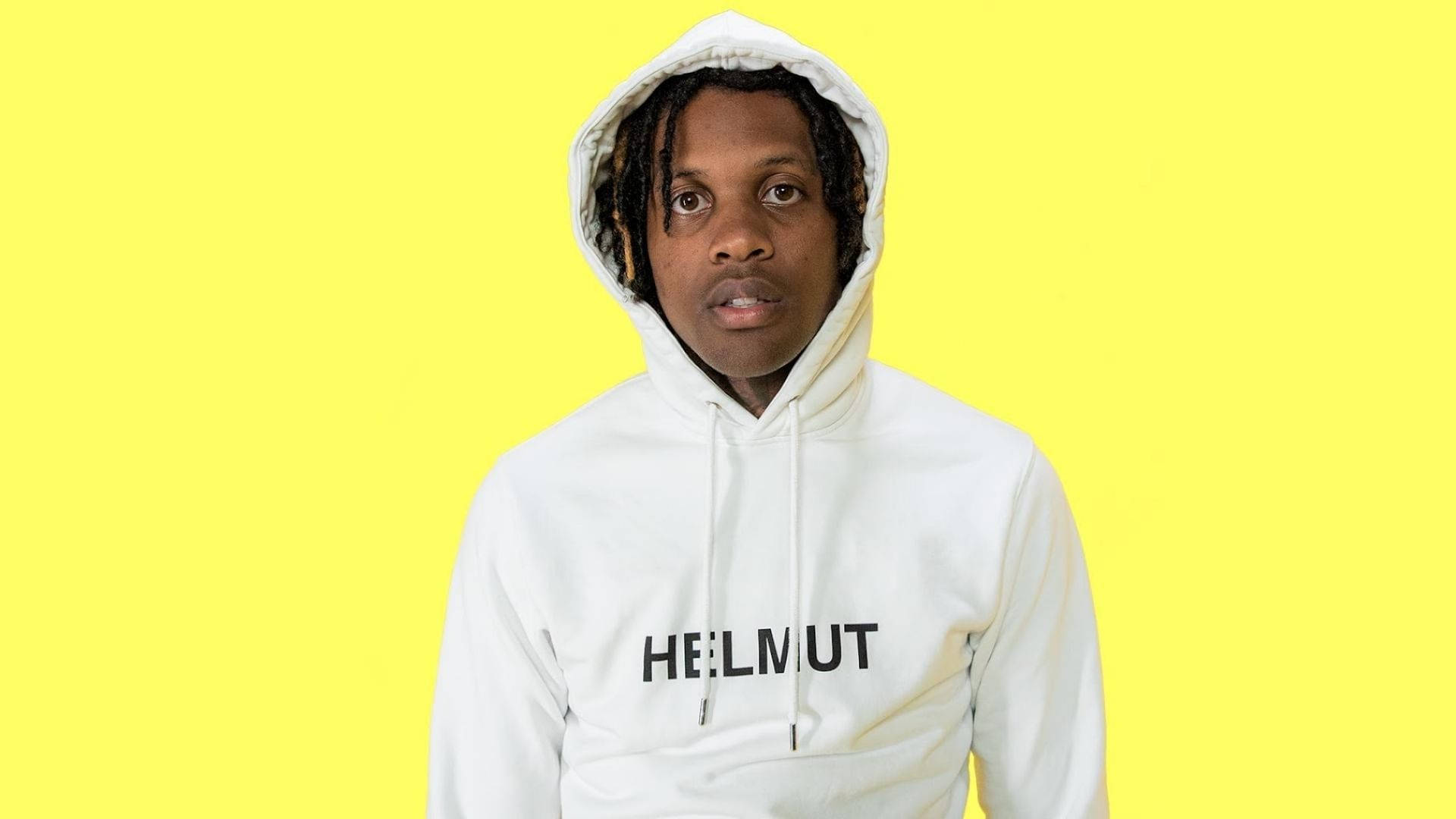 Lil Durk 穿著 Helmut 印花連帽衫 壁紙 — 一位留著辮子的年輕男子穿著一件白色連帽衫，上面印有'HELMUT'字樣，背景為亮黃色。