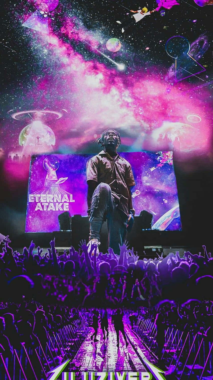 萬眾矚目——Lil Uzi Vert 新專輯震撼登場 壁紙 — 一位表演者站在音樂會舞台上，下方是宇宙紫色銀河天空，有UFO和歡呼的人群。