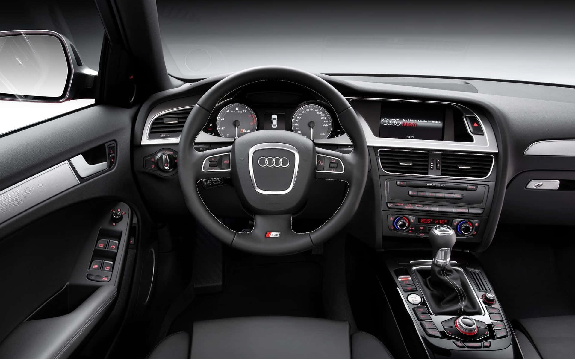 Audi S4 桌布 壁紙 — 豪華黑色奧迪汽車內飾，配備運動型方向盤和時尚儀表板控制。