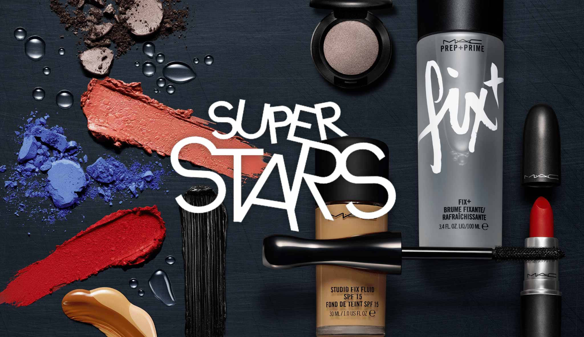 Mac Cosmetics 明星經典系列 壁紙 — 大膽的化妝品和鮮豔的顏料樣本在深色紋理表面上動態排列，帶有「SUPER STARS」文字。