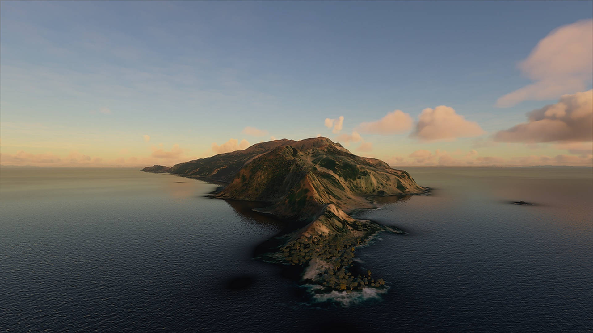 macOS Catalina 多雲天空 壁紙 — 崎嶇火山島的鳥瞰圖，日落時分，平靜的海水和柔和的金色雲彩。
