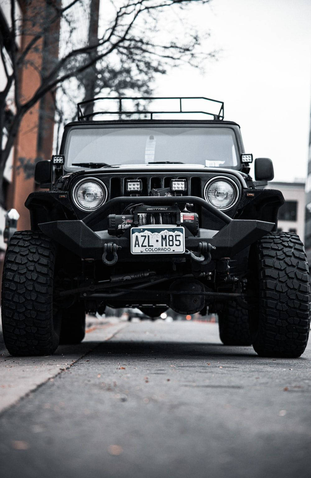 帶有科羅拉多車牌的黑色Jeep Wrangler停泊在城市街道上。