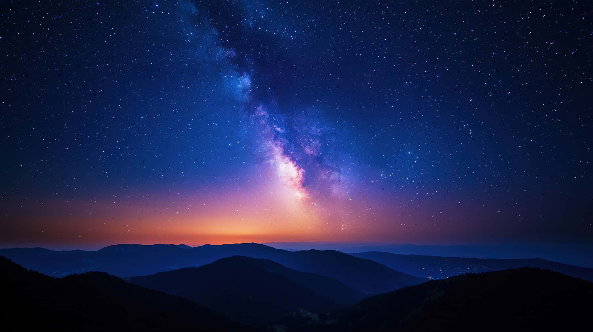 銀河系在星空下彎曲在黑暗的山脈剪影之上。