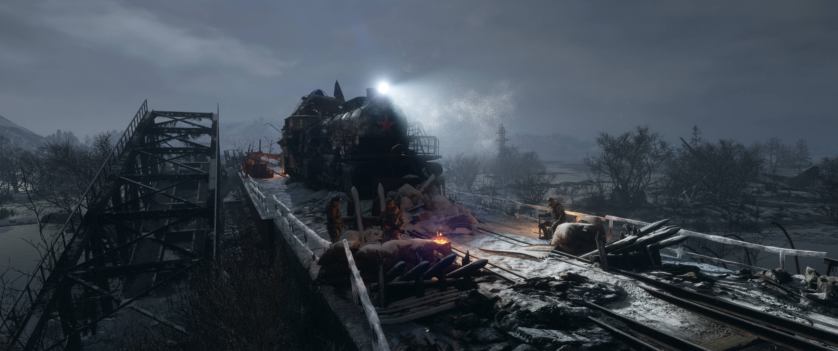 《Metro Exodus》毀損橋樑 3440x1440 壁紙 — 被雪覆蓋的火車殘骸在斷橋上，倖存者在陰沉天空下圍著營火取暖。