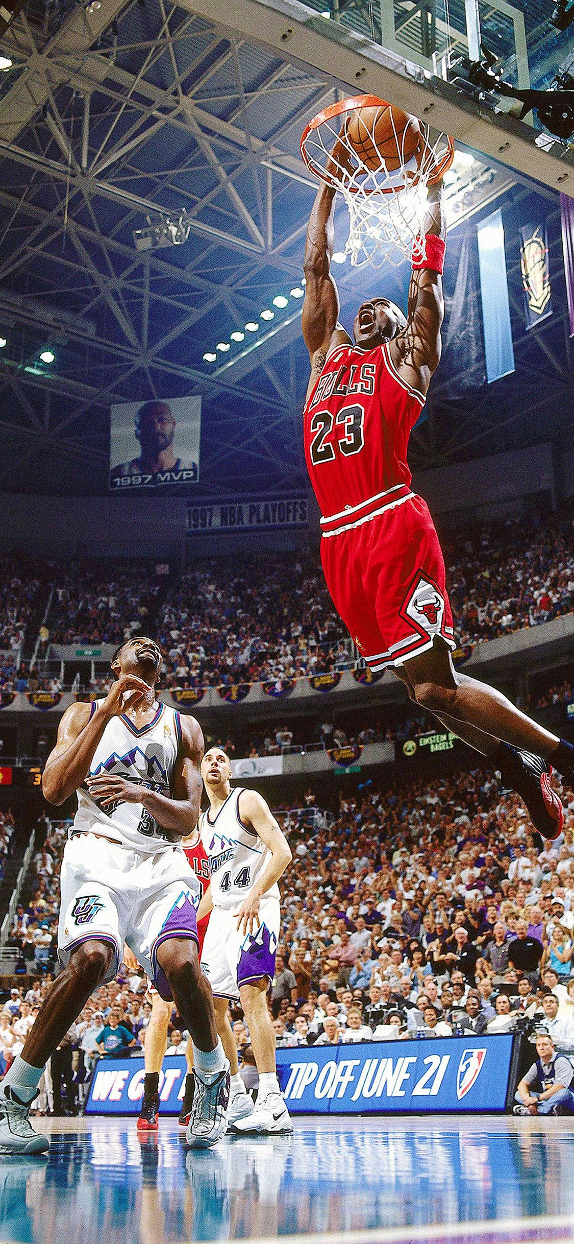 NBA iPhone 邁克爾·喬丹 1998年NBA總決賽 壁紙 — 米高佐敦穿著紅色公牛球衣在空中飛翔，在擠滿觀眾的NBA季後賽比賽中入樽。