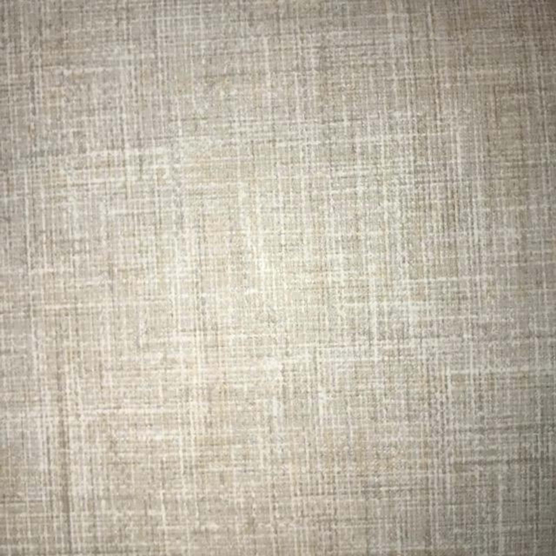 帶有編織紋理和柔和自然光線的米色亞麻布料。