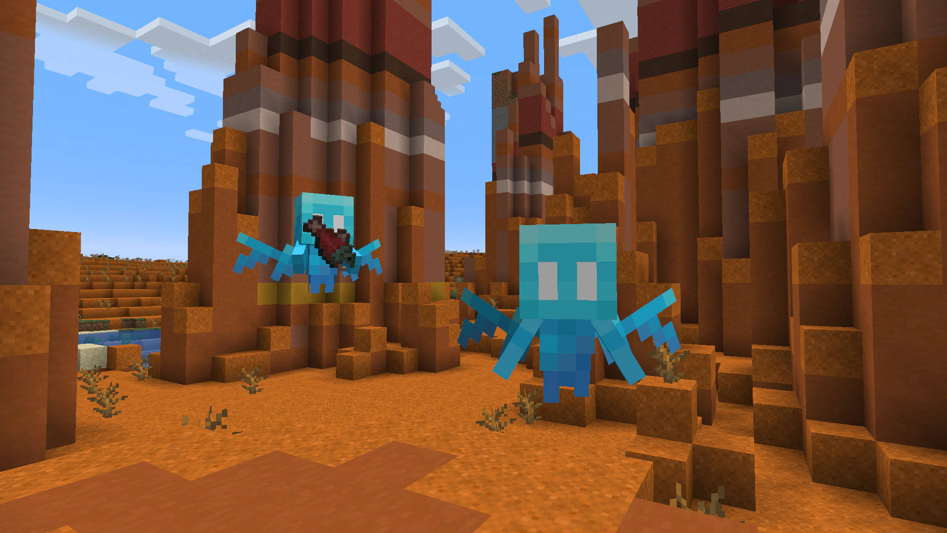 Minecraft 沙漠峽谷中的兩隻藍色蠑螈，塊狀地形和清澈天空。