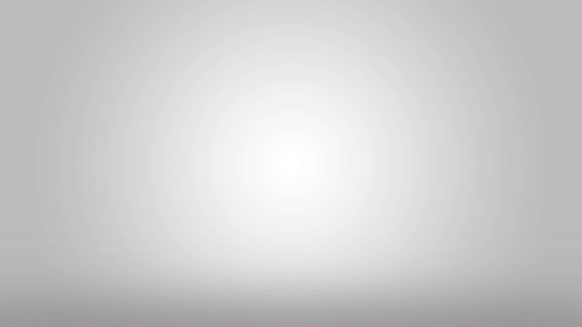 Grey Texture 桌布 壁紙 — 一個極簡漸變背景，從中心向柔和的灰色邊緣散發出柔和的白光。