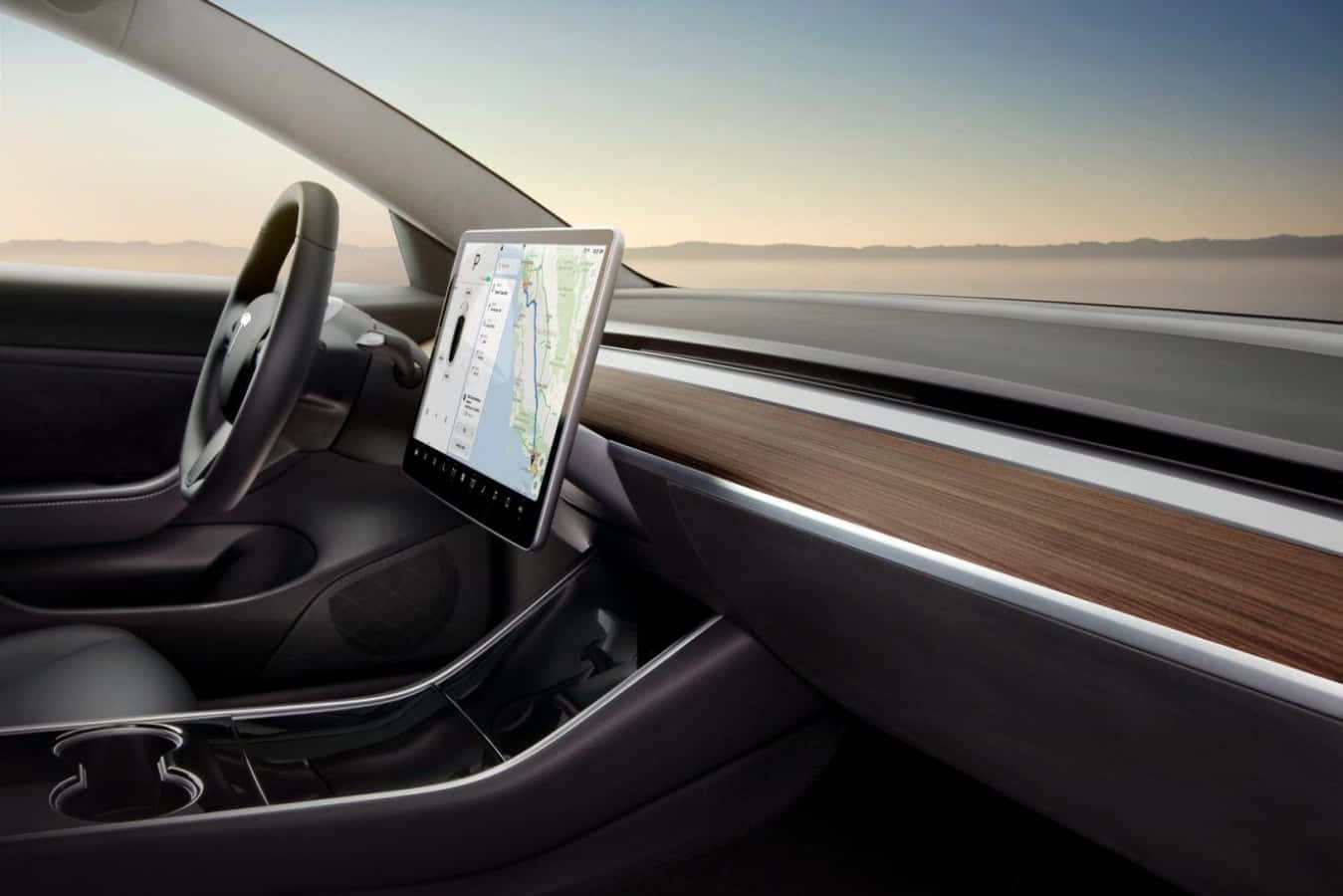 體驗未來，駕馭特斯拉Model 3 壁紙 — 時尚 Tesla 車廂內部，配備大型觸控屏幕，在朦朧沙漠日落背景下顯示地圖。