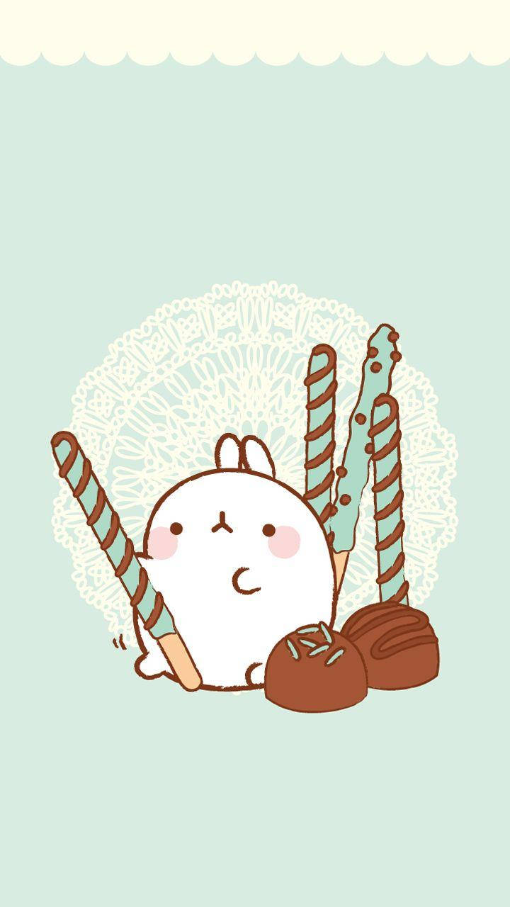 Molang 與巧克力 壁紙 — 一隻可愛的白兔仔，粉紅色臉頰，坐在薄荷色背景的蕾絲墊上，旁邊有朱古力松露和拐杖糖。