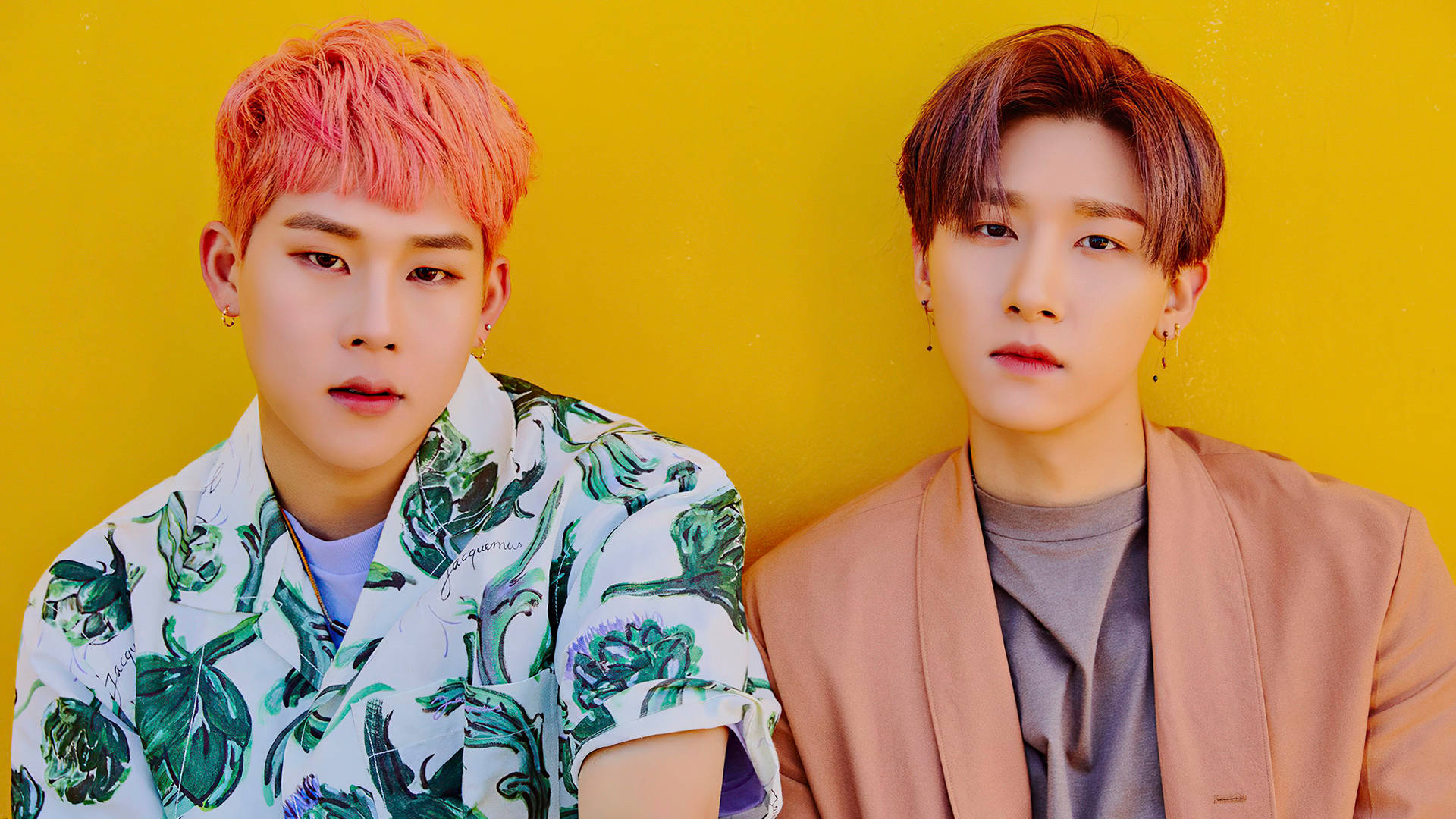 Monsta X Jooheon 與 IM 壁紙 — 兩名年輕男子擁有充滿活力的粉紅色和棕色頭髮，在鮮黃色牆壁前擺姿勢，穿著時尚對比鮮明的服裝。