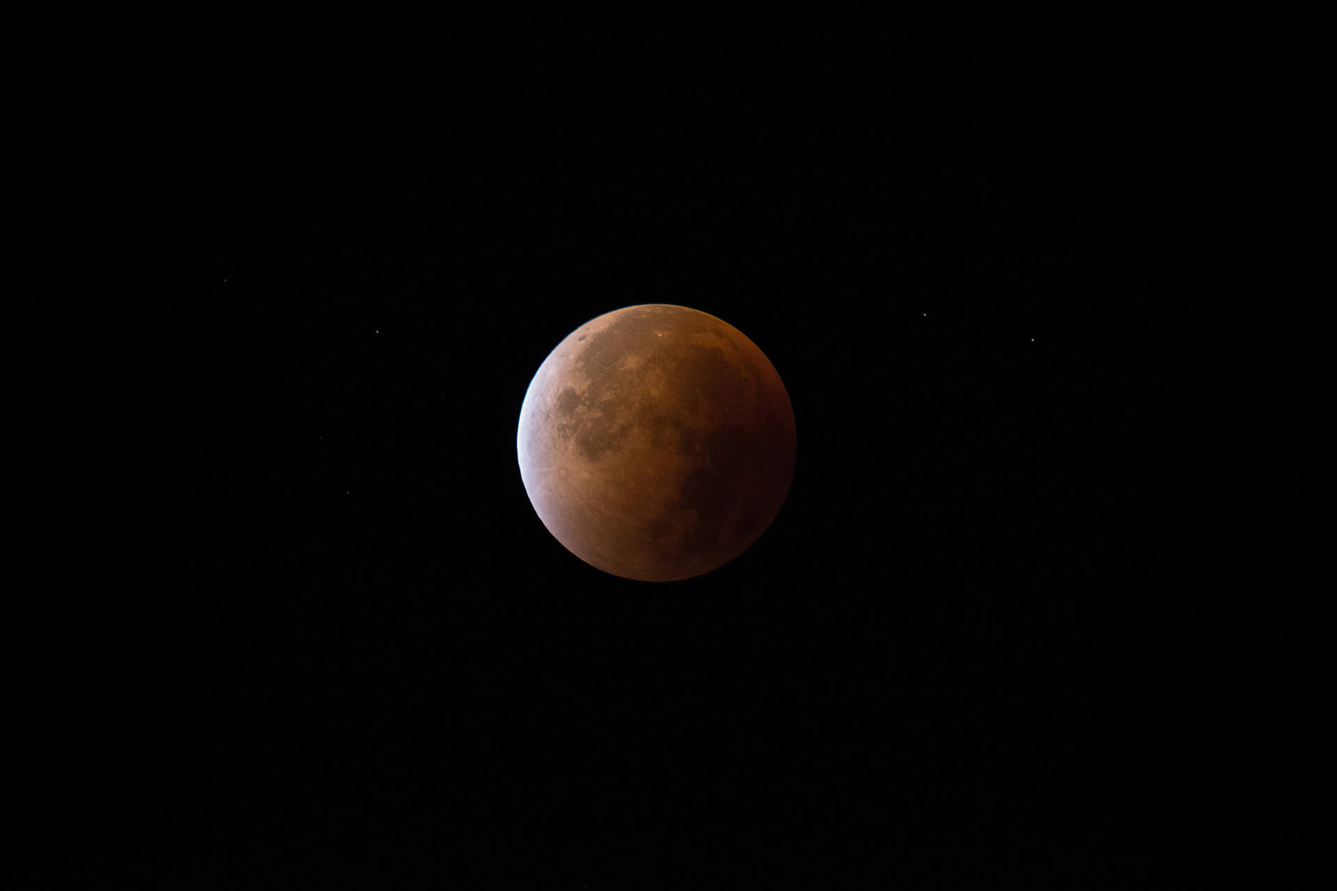 黑夜中漆黑的天空上的月亮。紅色月亮在夜空中。美學月景。