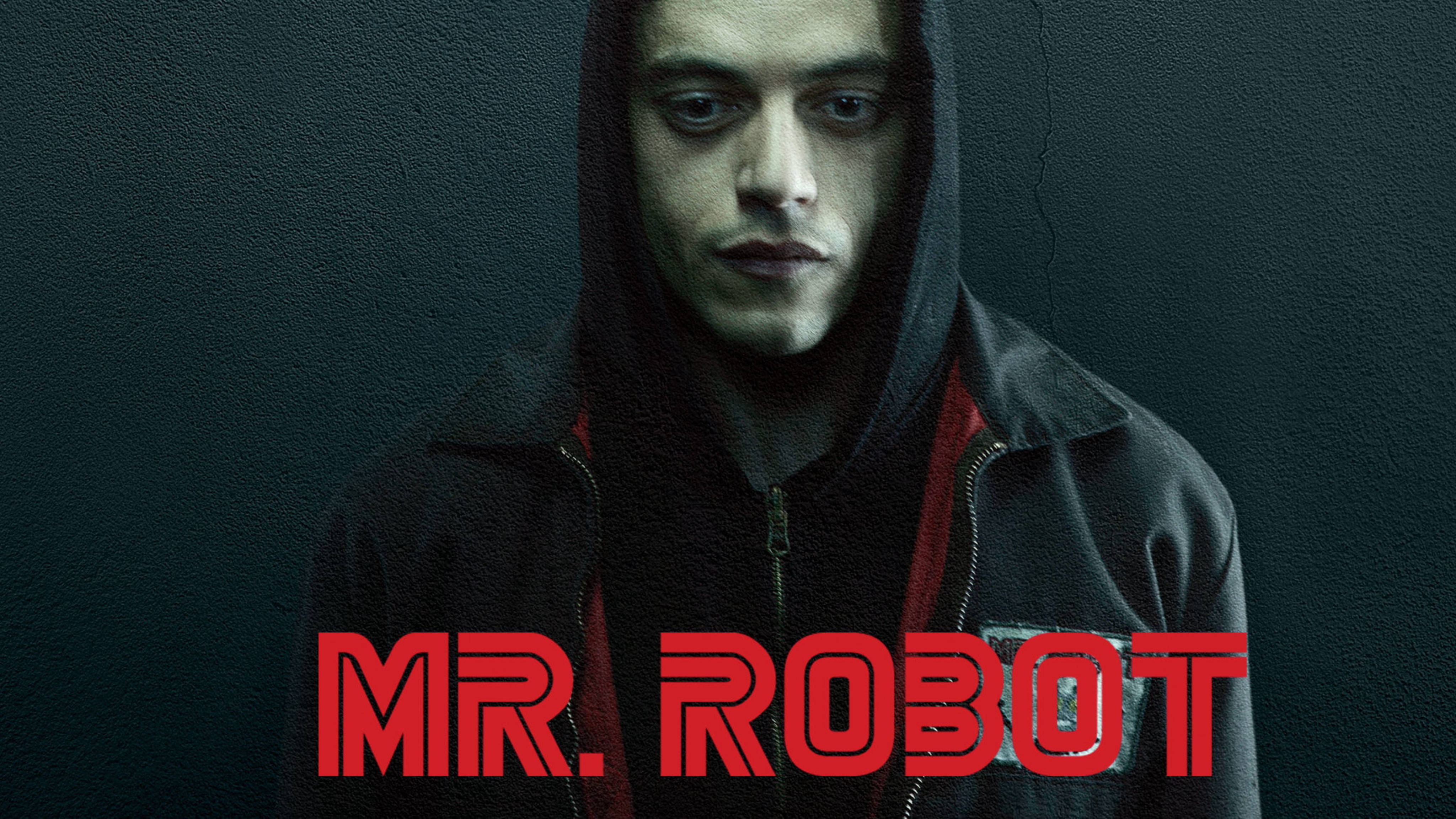 《Mr. Robot》電視劇第二季海報 壁紙 — 一個穿著深色連帽衫的男人，對著一面有裂縫的牆壁，牆上有粗體紅色「MR. ROBOT」文字，他凝視著。