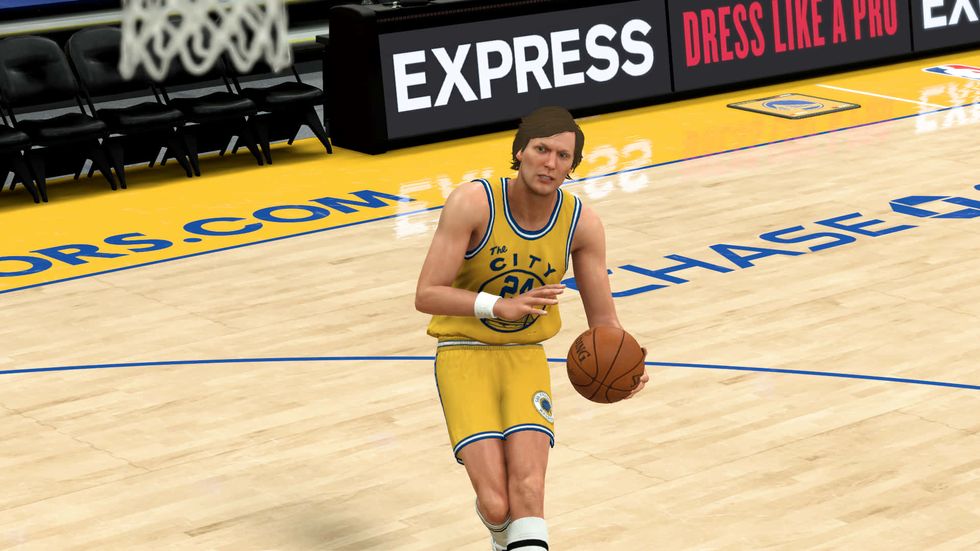 NBA 2K《The City》瑞克·巴里 球衣編號24 壁紙 — 一名身穿黃色「The City」球衣的籃球運動員在拋光木地板上運球，背景有「EXPRESS」標誌。