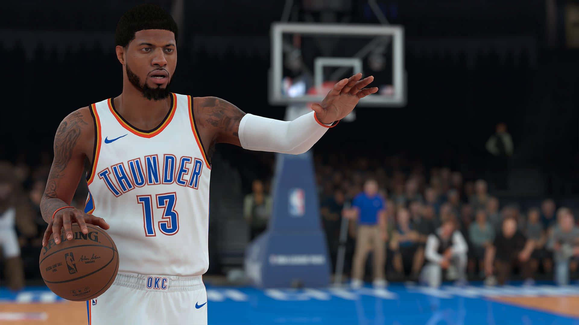 NBA 2K 賽事激情畫面 壁紙 — 一名身穿白色雷霆隊球衣的籃球運動員在燈光明亮的球場上拿著球並做手勢，身後是模糊的人群和籃框。