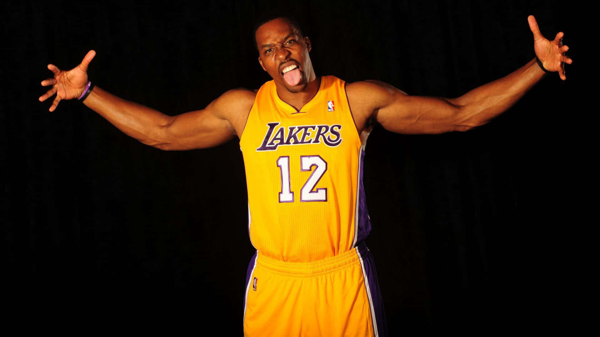 NBA球員搞怪表情照 壁紙 — 一名身穿黃色湖人隊12號球衣的籃球運動員，在黑色背景前伸出舌頭並張開雙臂。