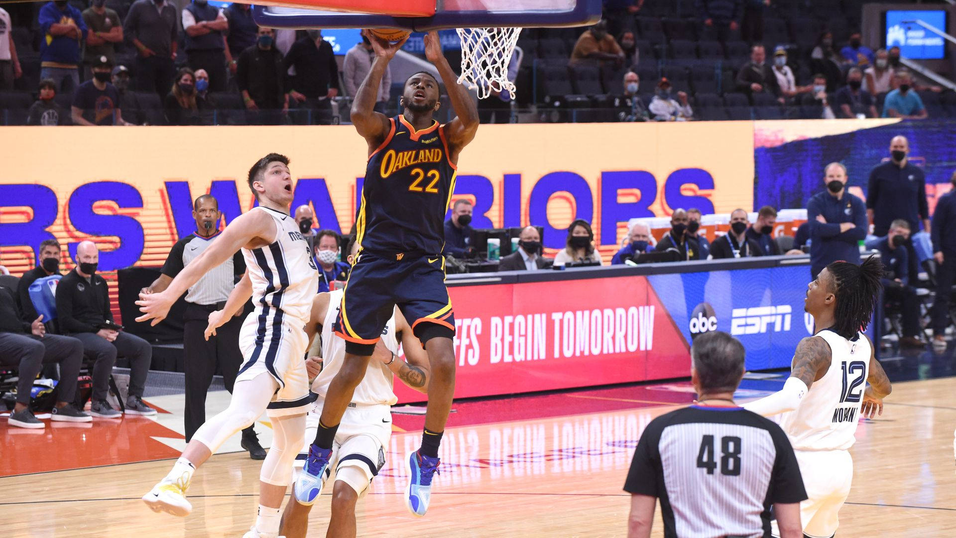 NBA總決賽經典新奧爾良鵜鶘隊 壁紙 — 一名身穿奧克蘭勇士隊球衣的籃球運動員在激烈的比賽中扣籃，防守球員跳起試圖封阻。