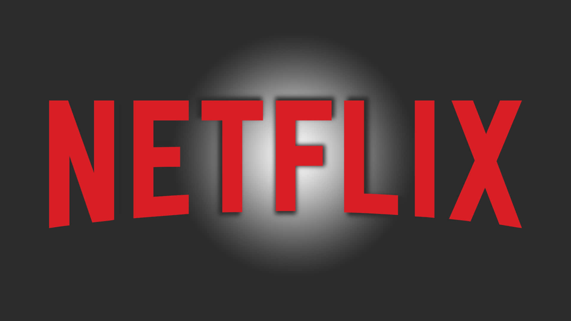 在深色背景上被聚光燈照亮的紅色Netflix標誌。